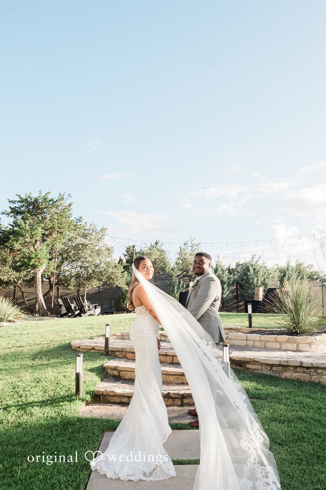 Lilly + Cade Bride and groom looking back together at The Terrace Club captured by Austin Wedding Photographers from Original Weddings.