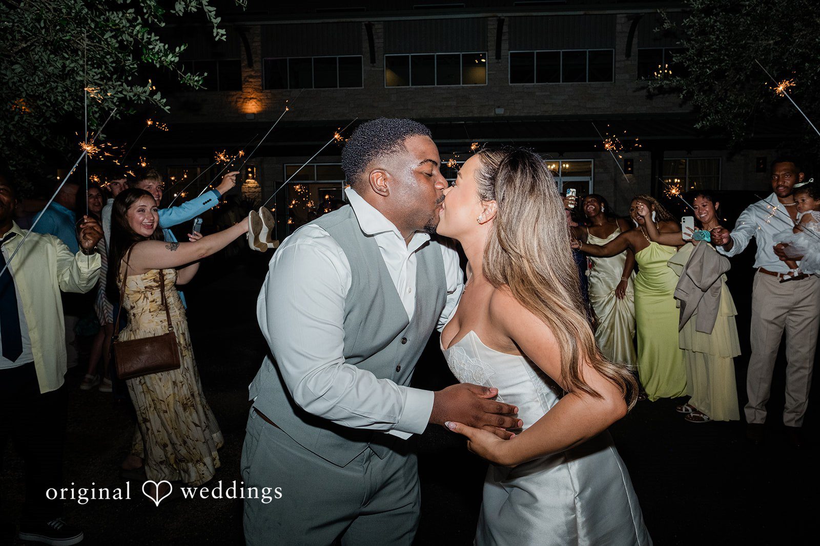 Lilly + Cade Bride and groom sharing a kiss surrounded by sparklers at The Terrace Club.