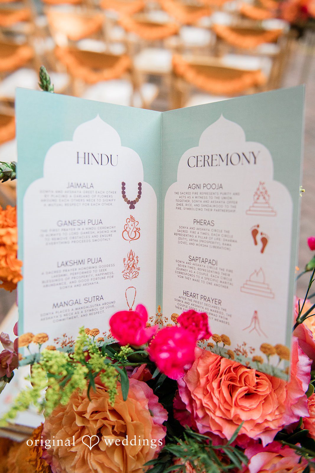 Sonya + Akshaya Colorful floral arrangements placed in front of printed wedding programs.