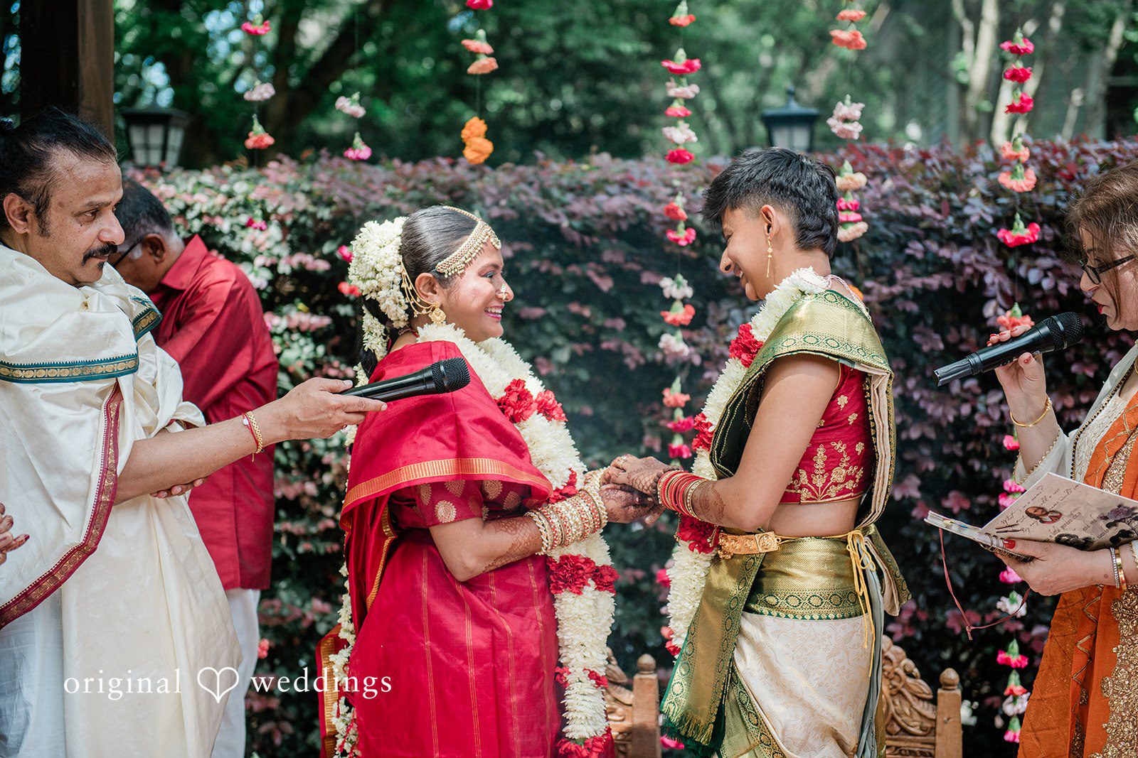 Sonya + Akshaya A bride and groom facing each other while exchanging vows during their ceremony.