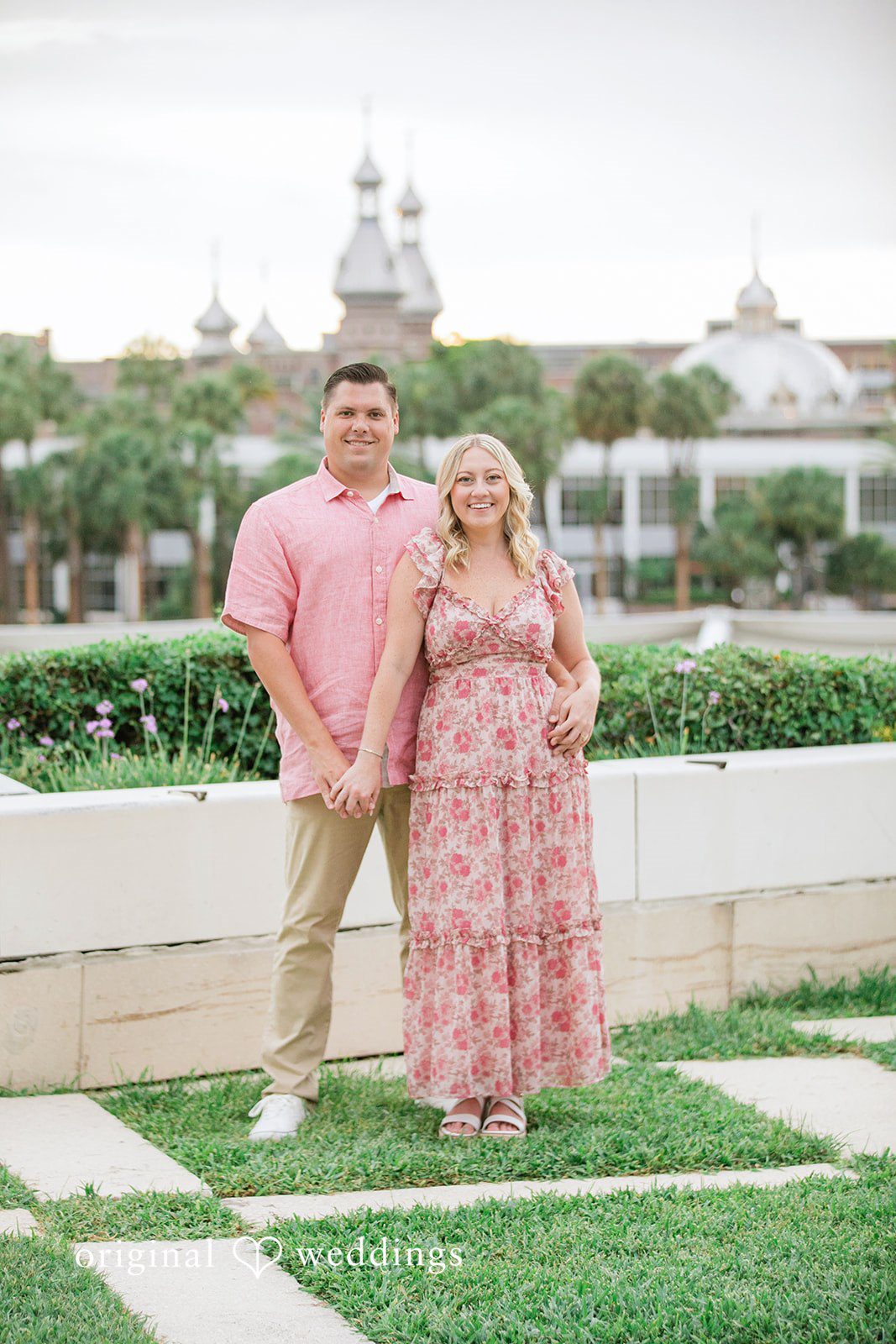 Taylor + Jack Couple standing together on a grass and stone checkered path.