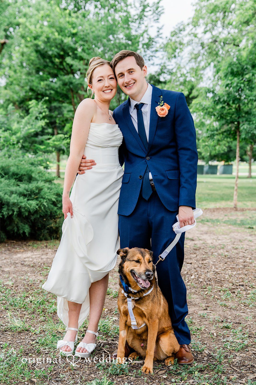 Sophia + Miles A bride and groom posing together with a brown dog sitting in front.