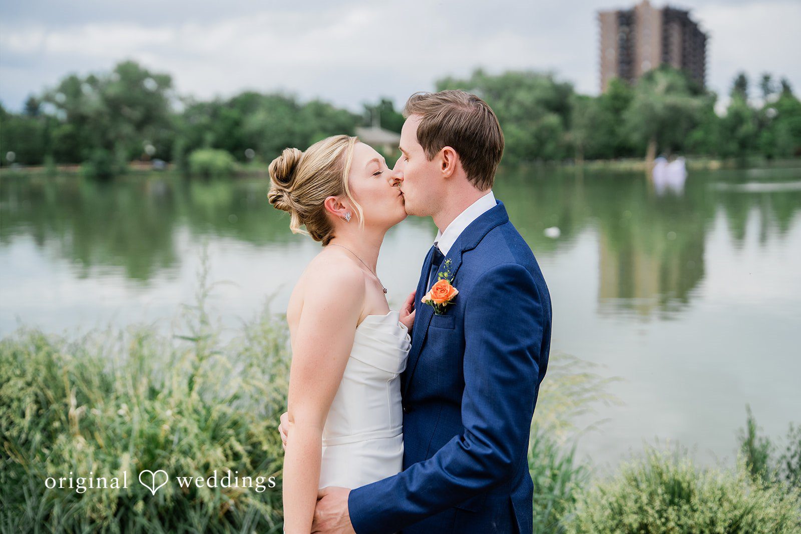 Sophia + Miles A bride and groom sharing a romantic kiss at Washington Park Boat House.