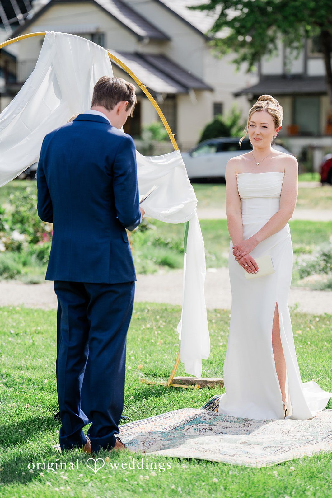 Sophia + Miles A bride and groom standing together at a wedding altar under a white canopy structure.