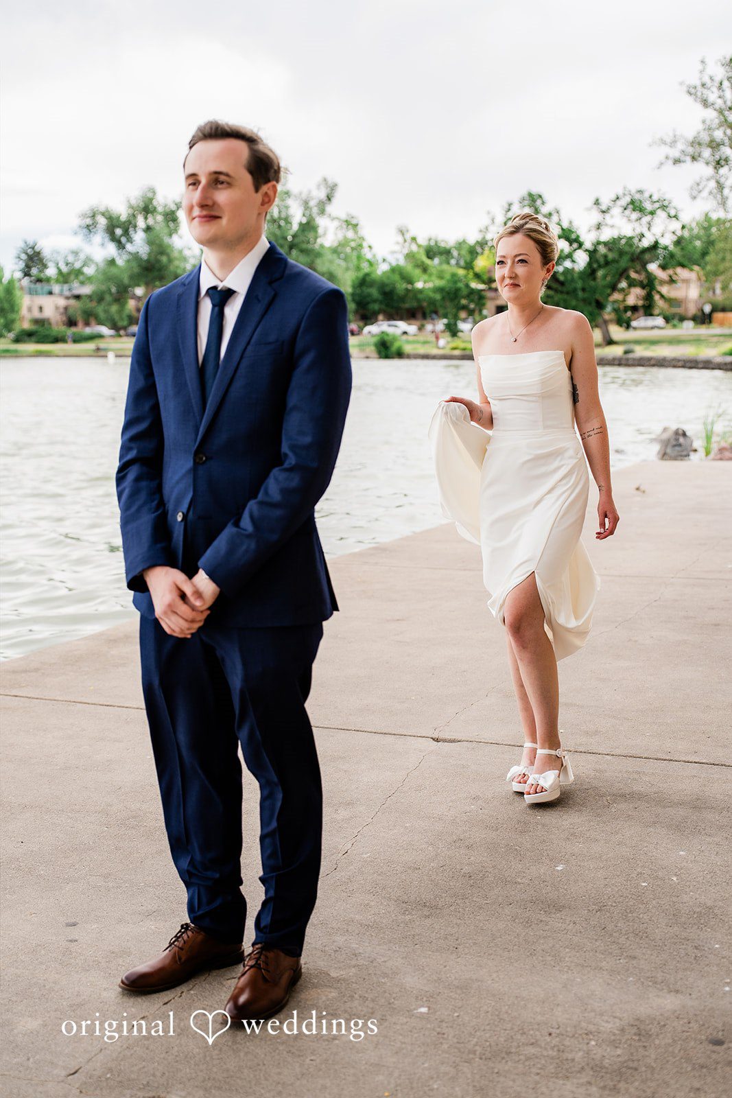 Sophia + Miles A groom waiting with his back turned as the bride walks up behind him.