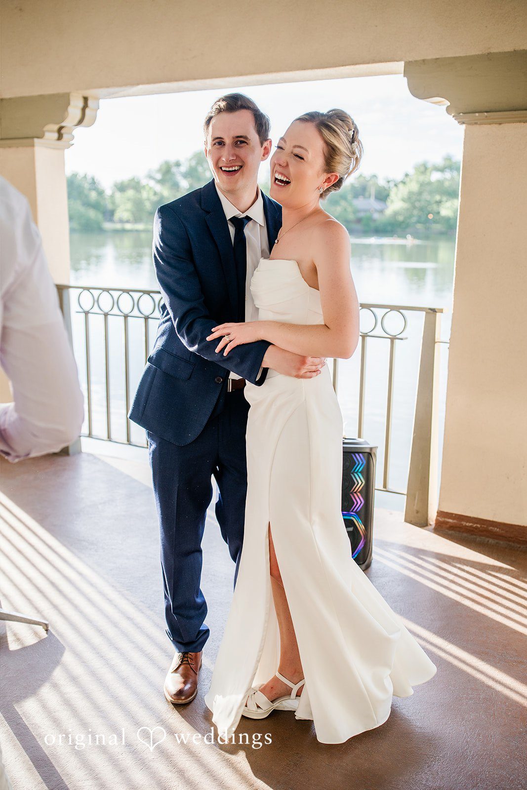 Sophia + Miles A joyful groom and bride smiling at each other by the water.