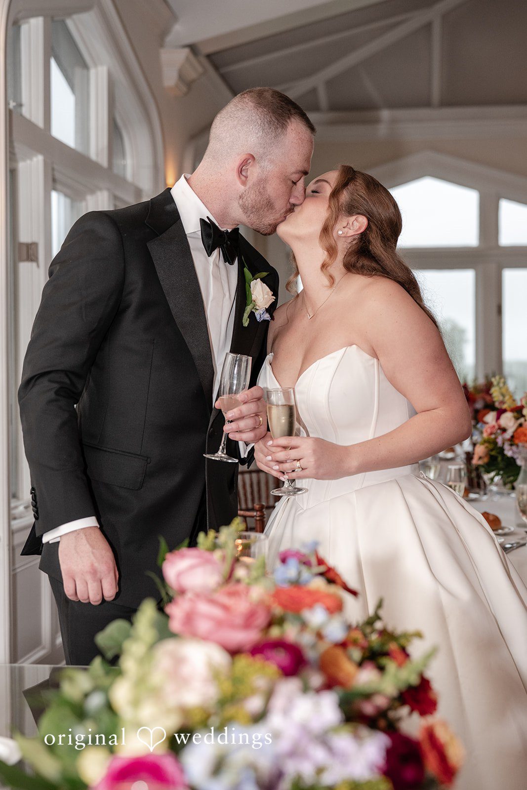 Christina + Christopher Bride and groom kissing inside the venue