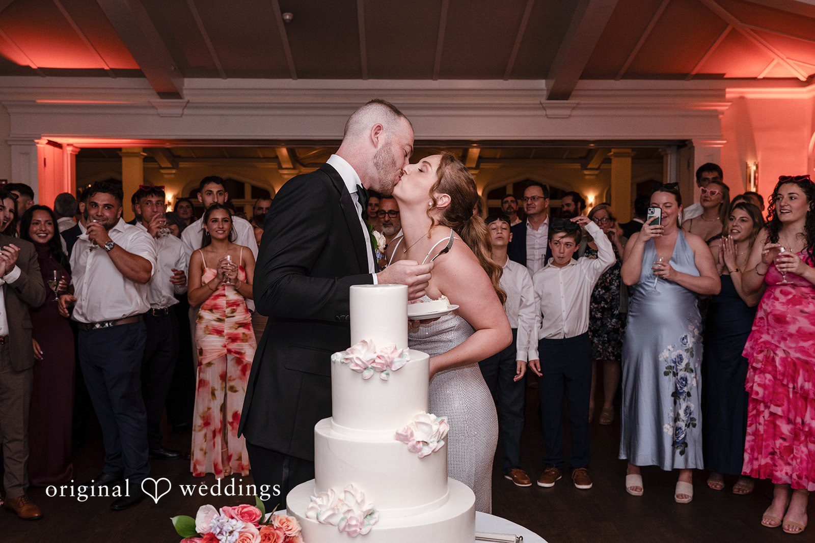 Christina + Christopher Bride and groom kissing after cutting the cake