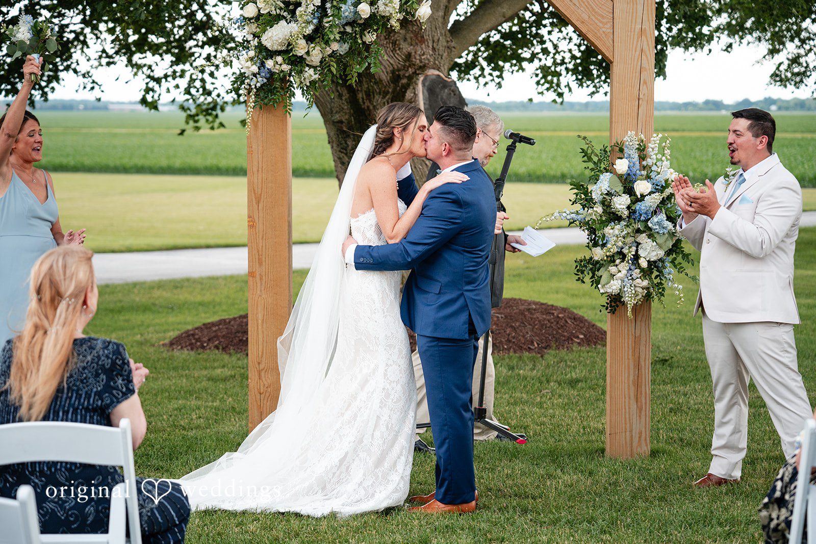 Bride and groom sharing their first kiss after the ceremony