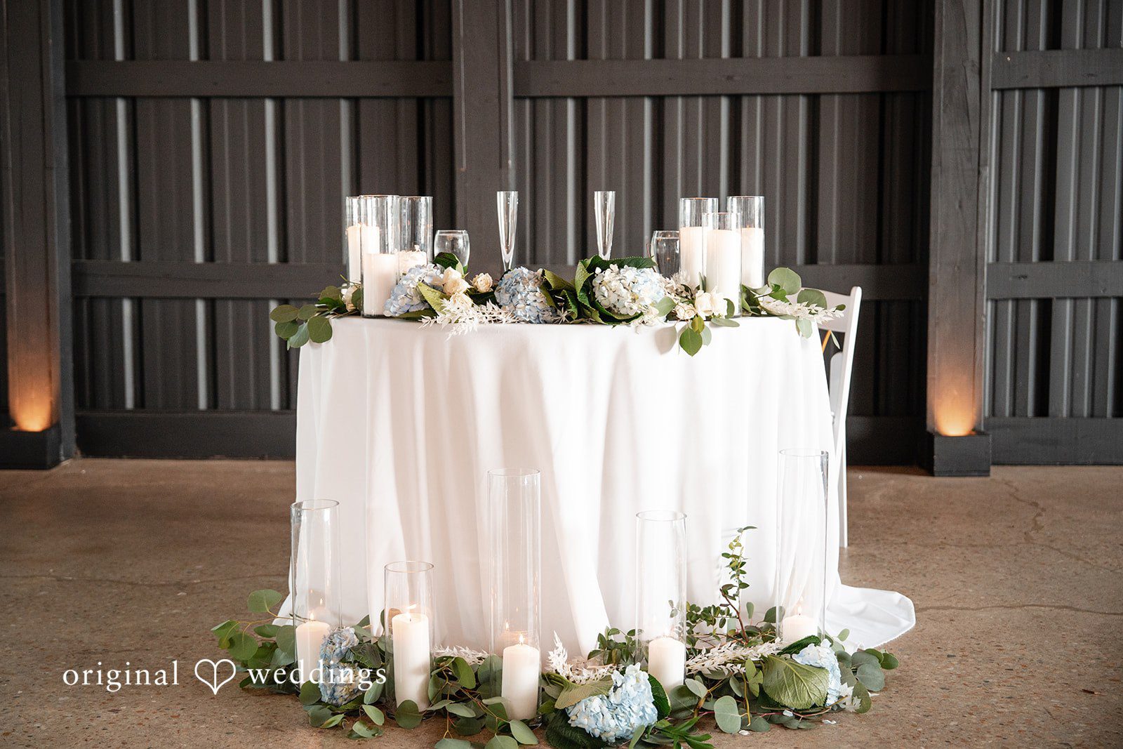 Romantic table decorated with candles and blue hydrangeas at White Stone Events
