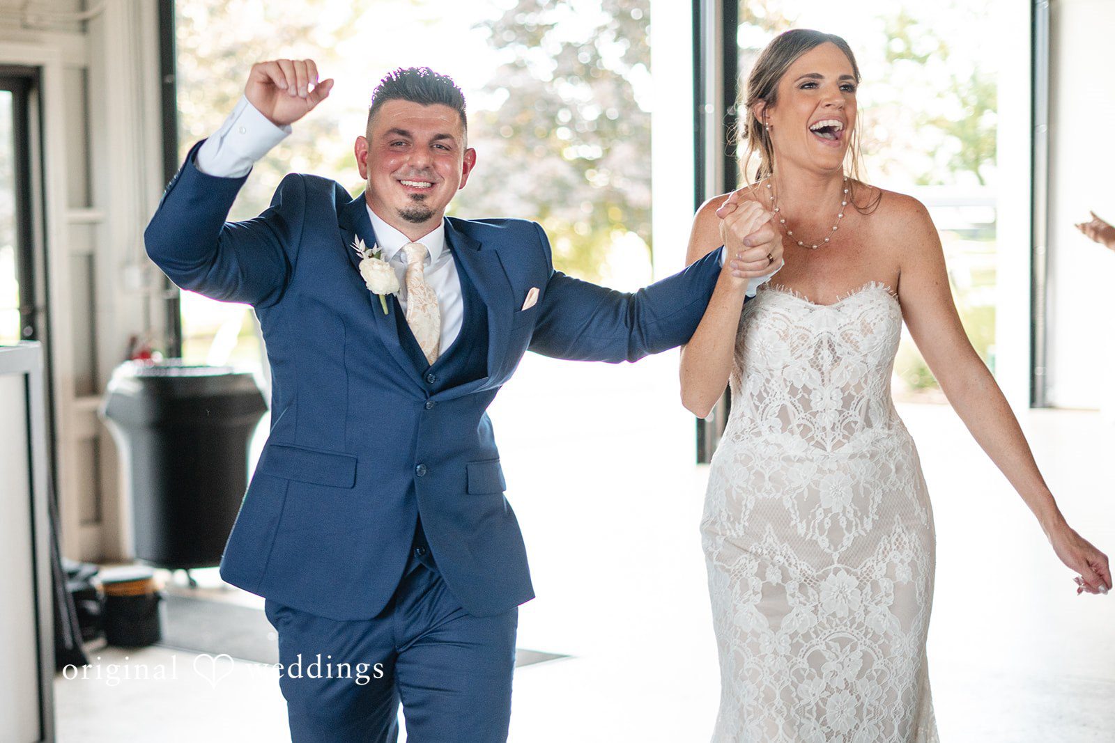 Bride and groom celebrating their lively reception entrance with joyful smiles