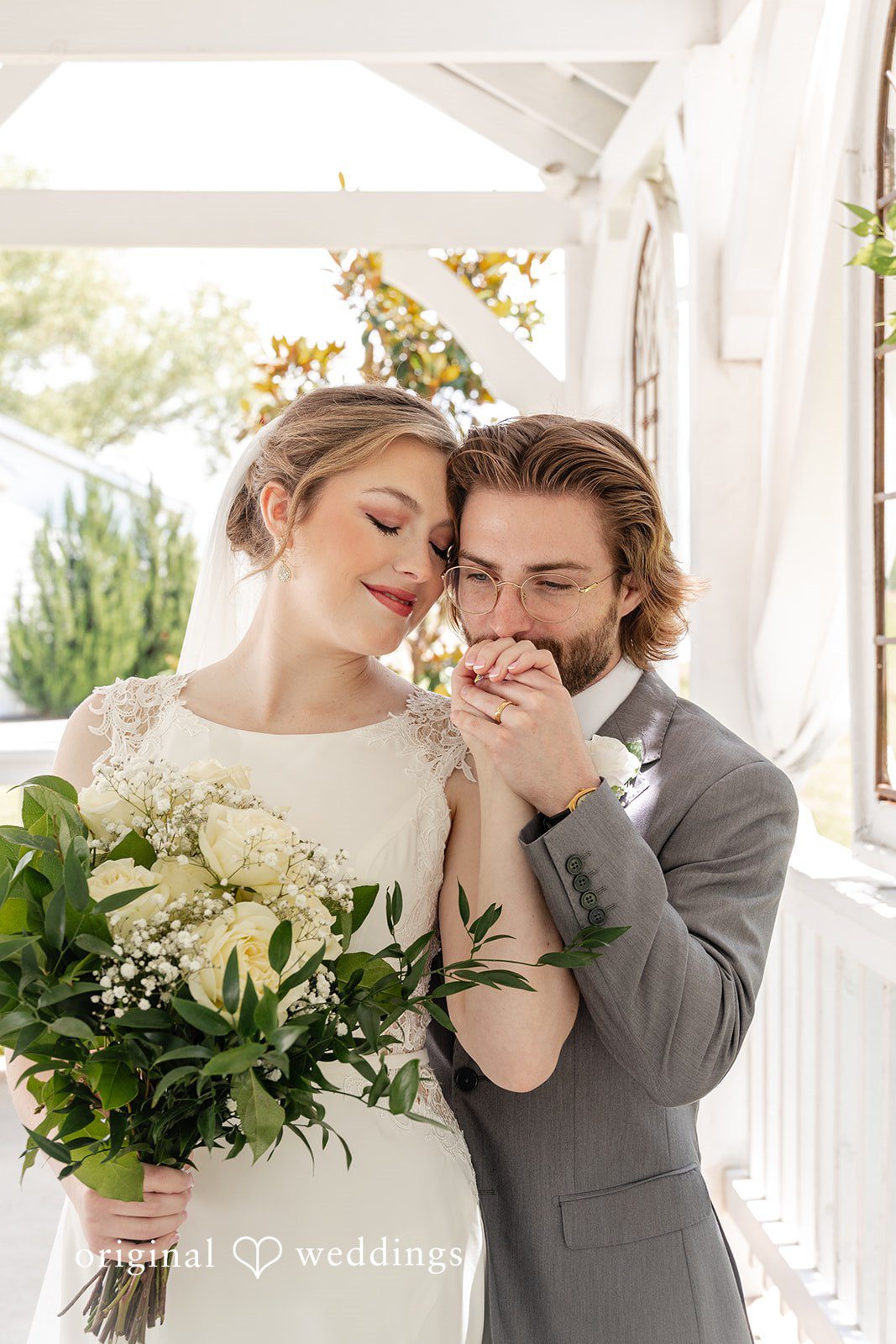 Anna Rose + Jacob The groom kisses the bride's finger
