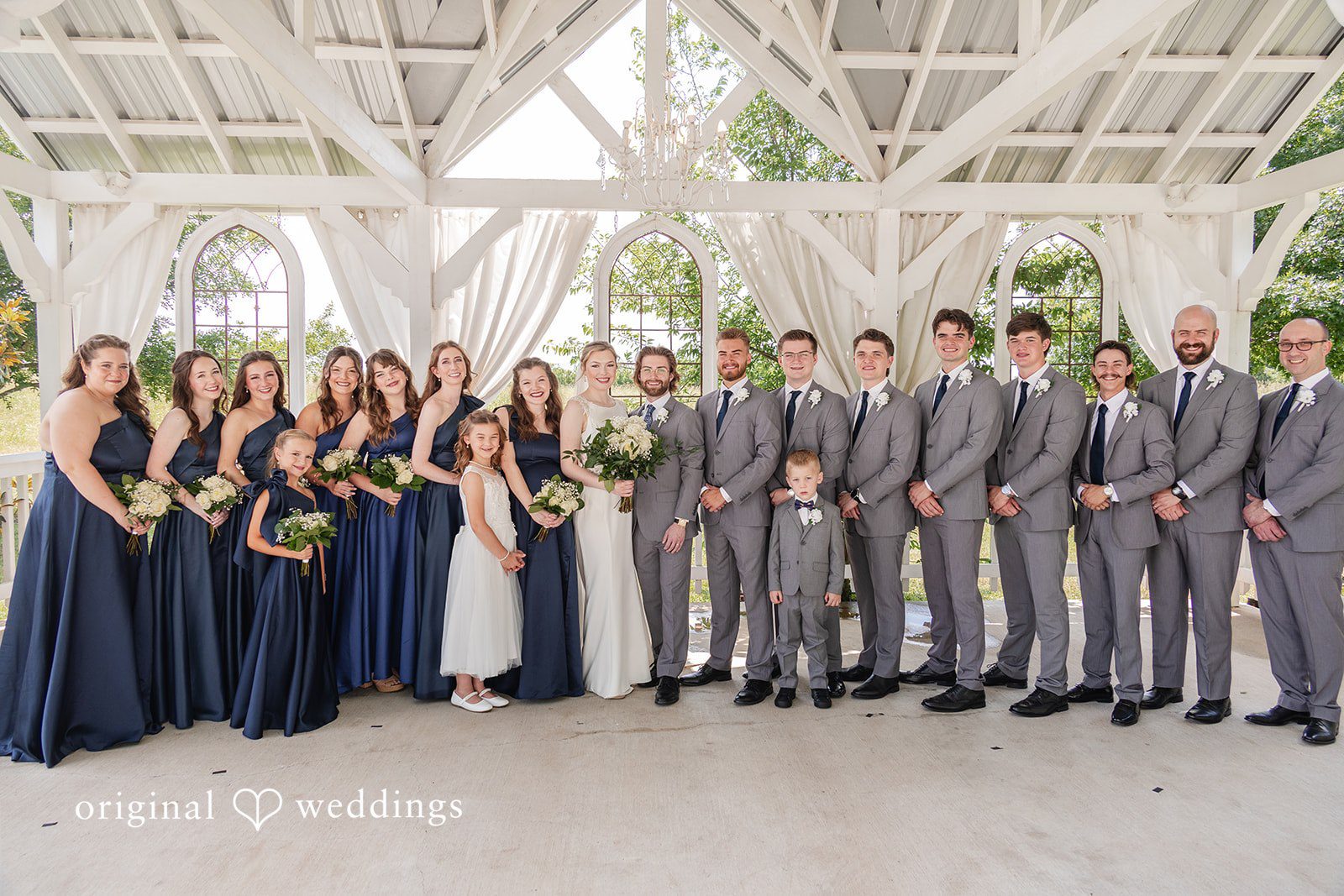 Anna Rose + Jacob Our Dallas wedding photographers at Original Weddings captured a stunning portrait of the couple and their bridal party at Willow Creek