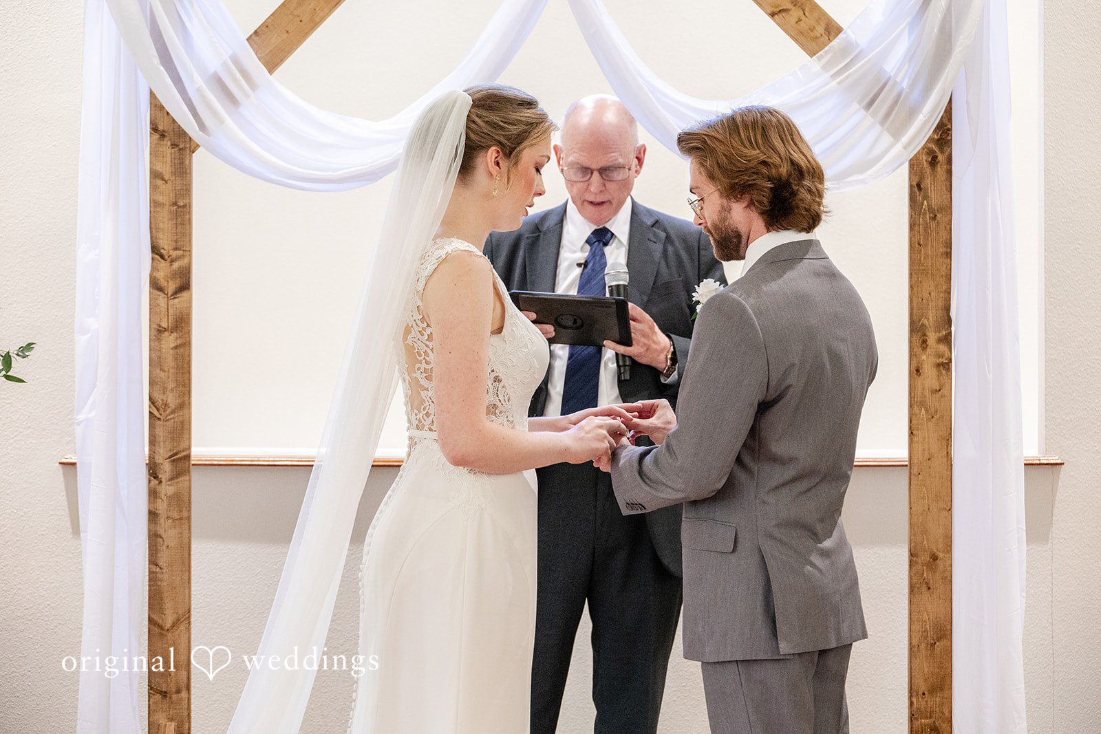 Anna Rose + Jacob The groom puts a ring on the bride's finger