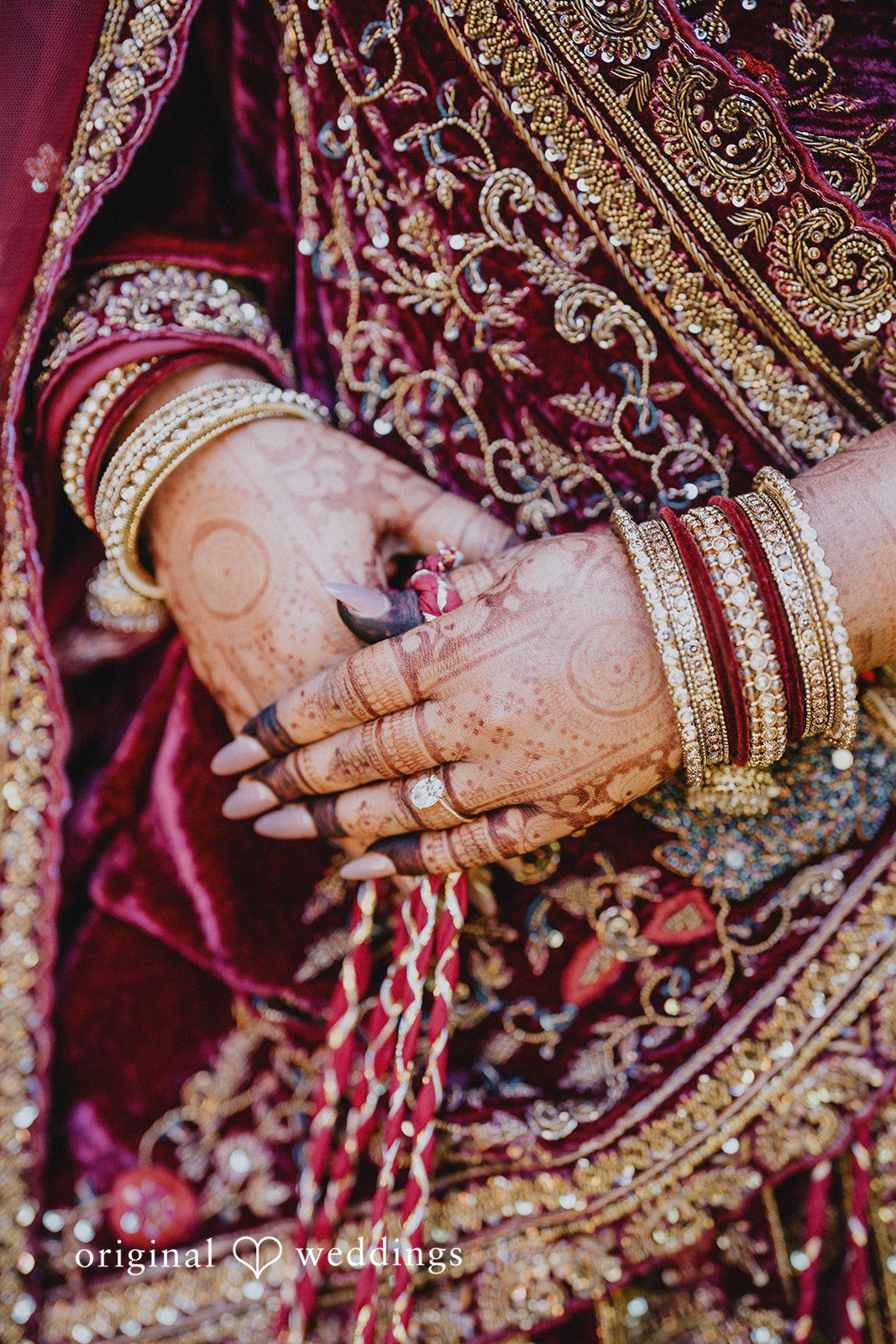 Close-up of the bride showing wedding ring and elegant mehndi artwork at Willows Lodge