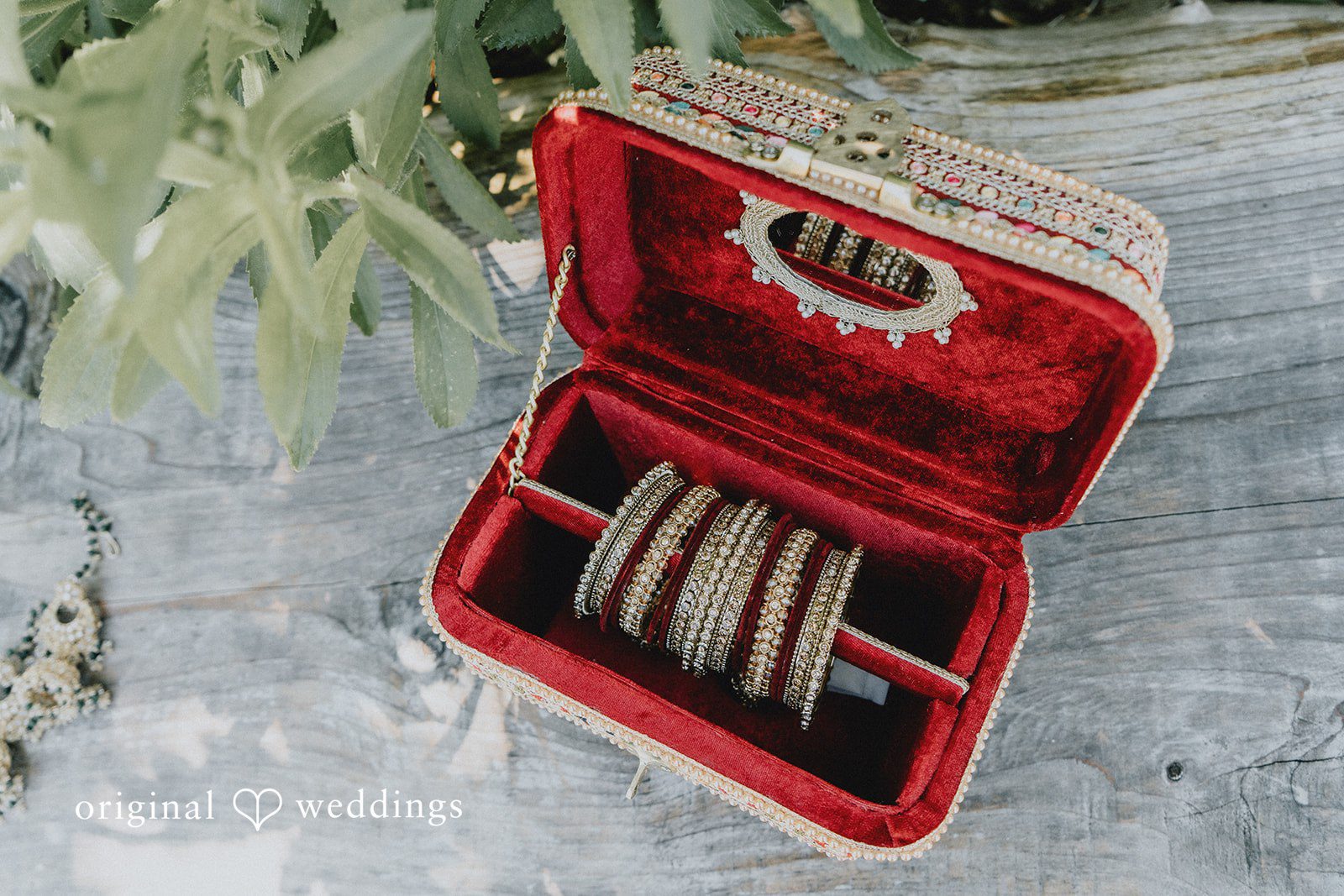 Close-up of traditional bridal bangles inside a luxurious velvet jewelry box at Willows Lodge