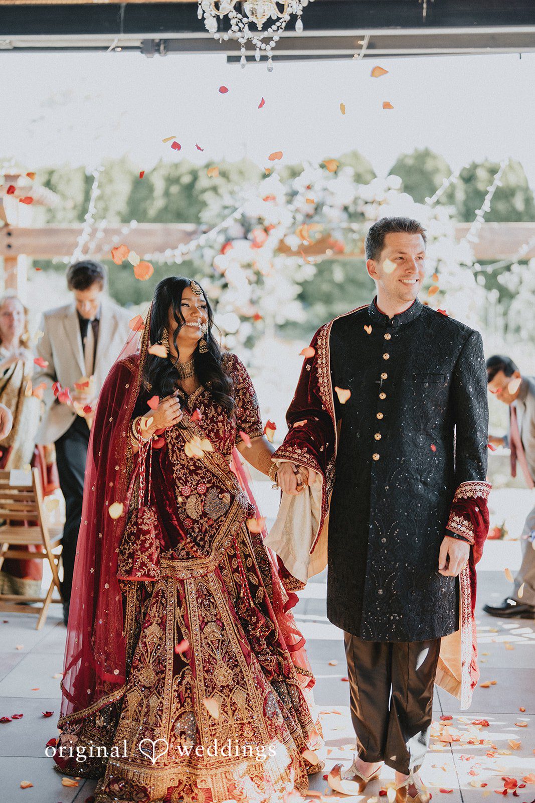 Newlyweds walking hand in hand after the ceremony