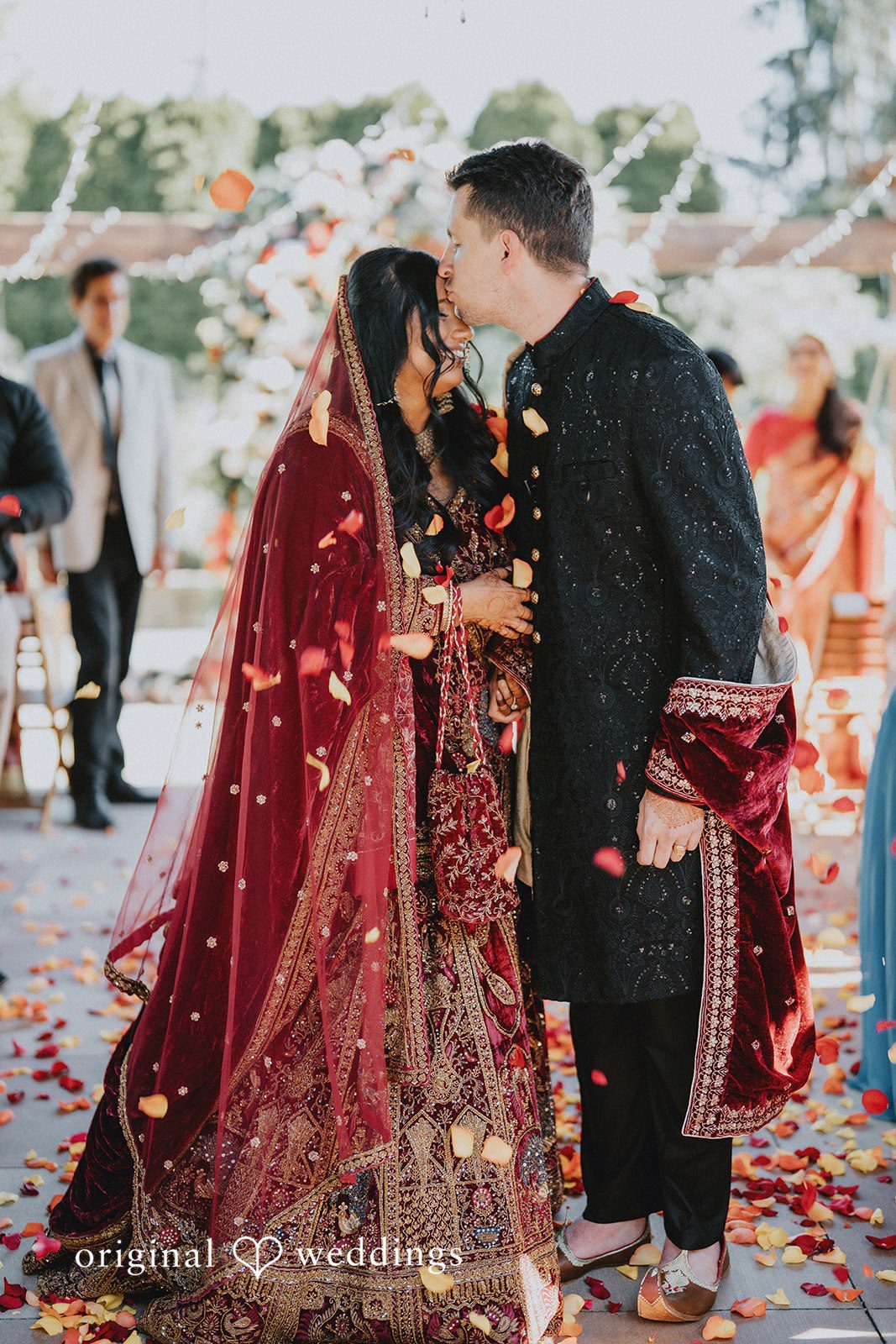 Groom kissing bride forehead with love