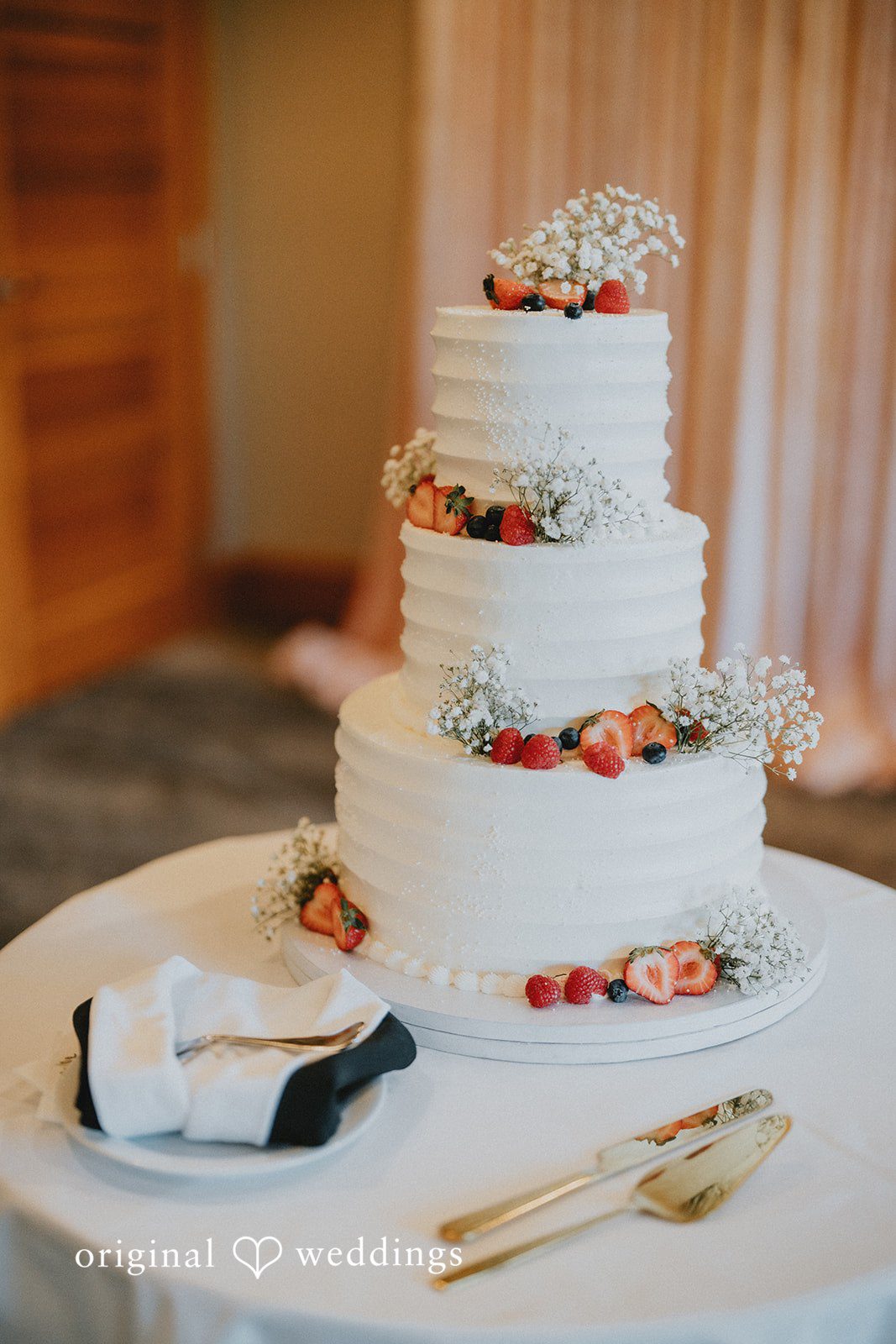 Close-up of a beautifully decorated multi-tier wedding cake with elegant floral details