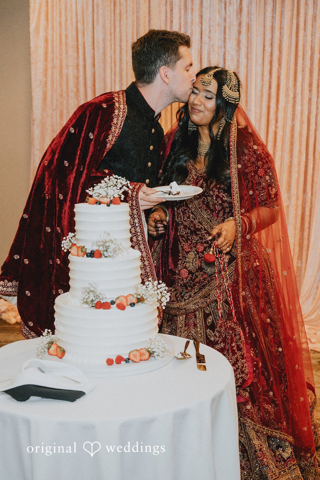 Bride and groom sharing a joyful cake-cutting moment at Willows Lodge