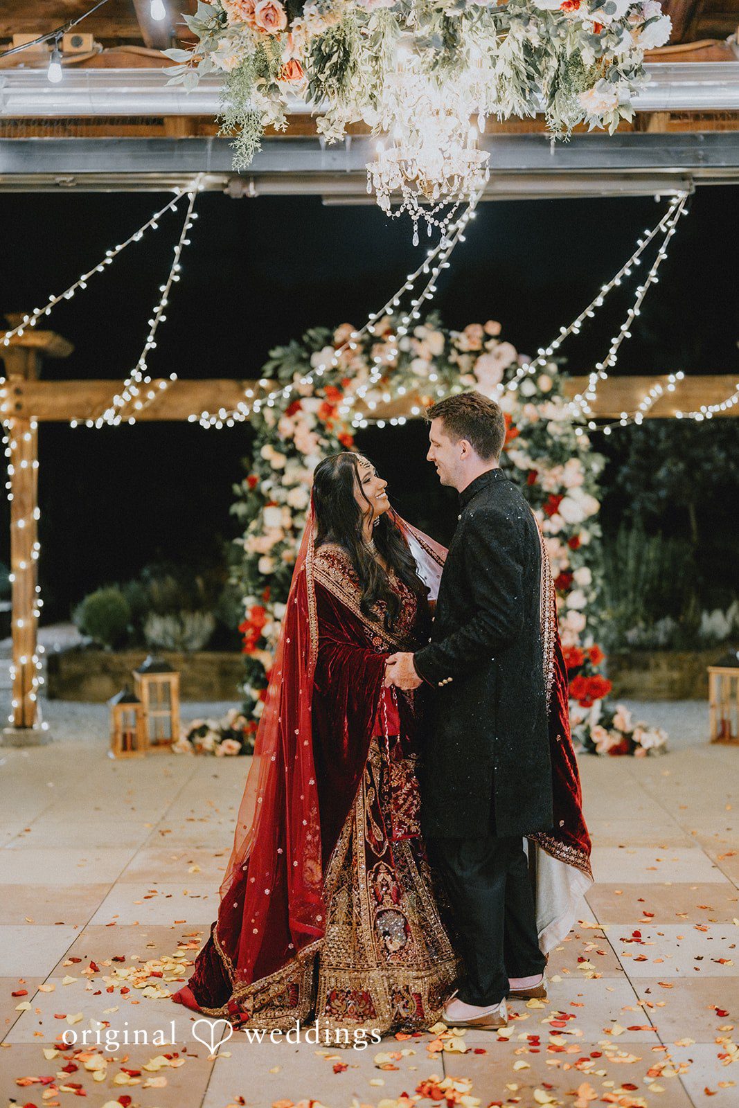 Bride and groom smiling while dancing together.