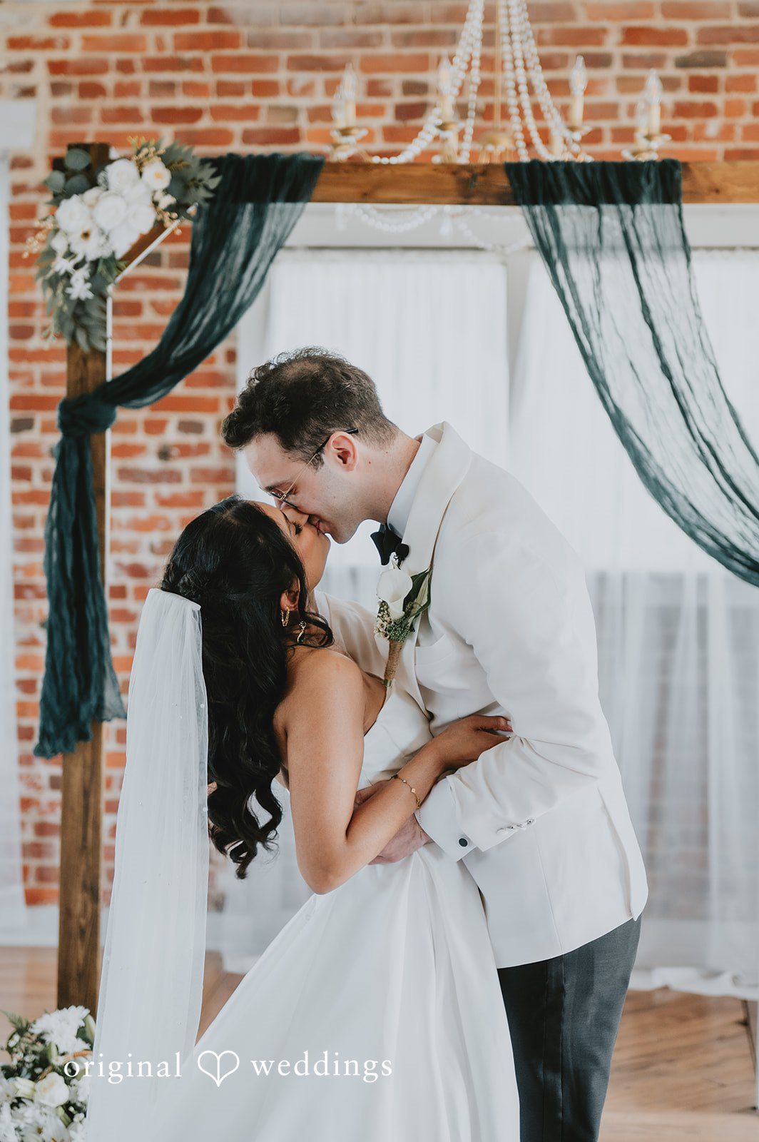 The couple shares a kiss