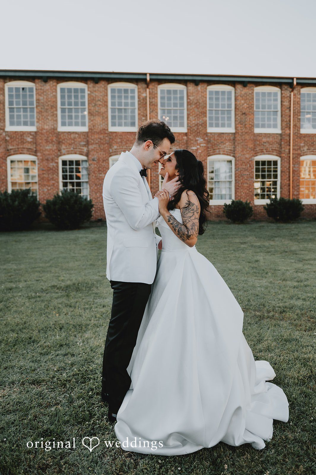The couple shares a kiss in the garden