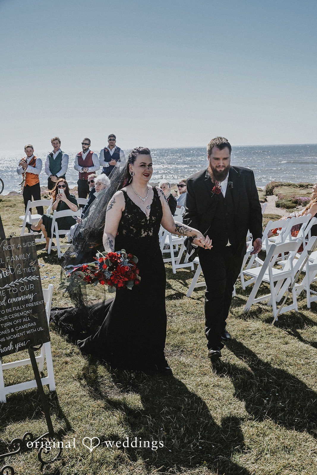 Bride and groom walking down the aisle together after their ceremony.