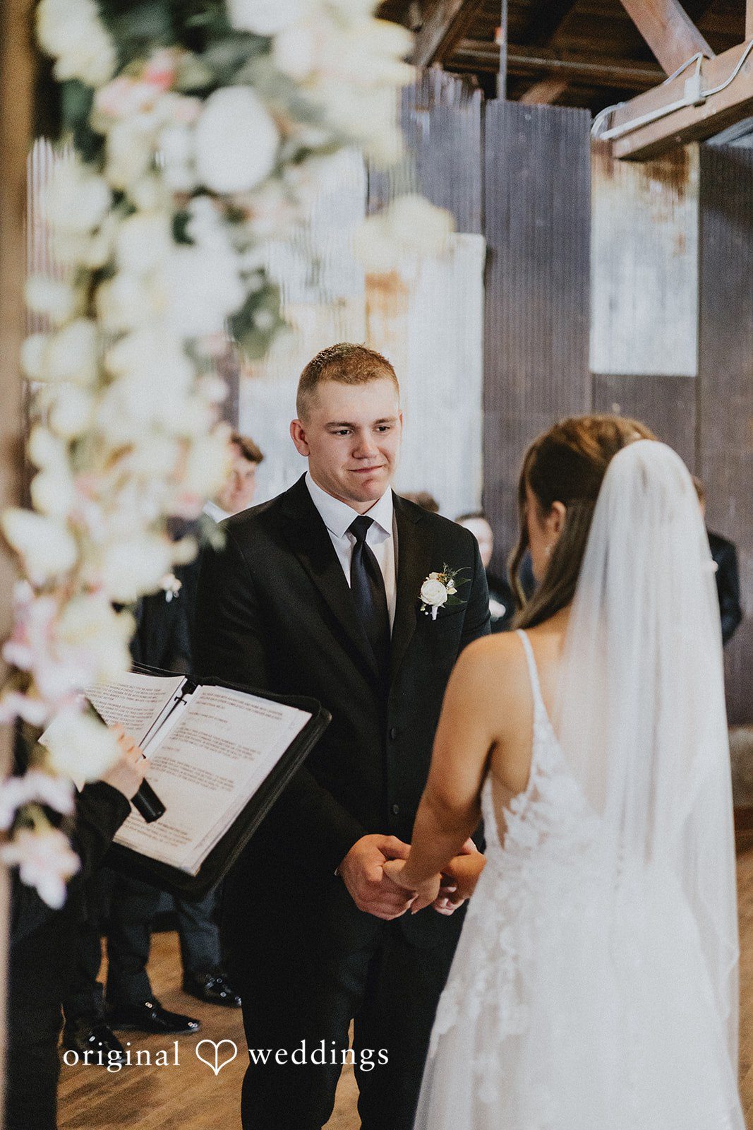 Emily + Ethan Groom looking at the bride during the wedding vows.