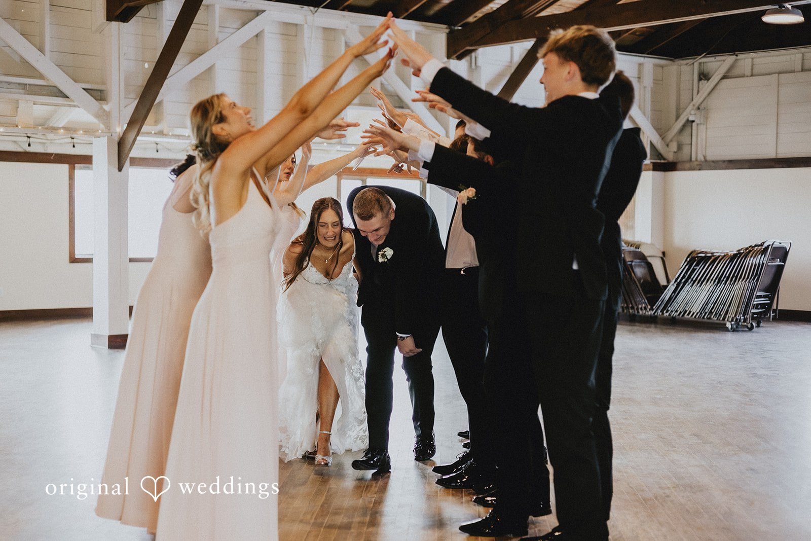Emily + Ethan Bride and groom making a grand entrance into their reception hall.