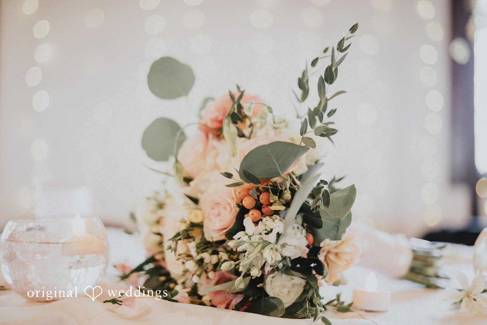 Emily + Ethan Close-up of a rustic floral arrangement with white roses.