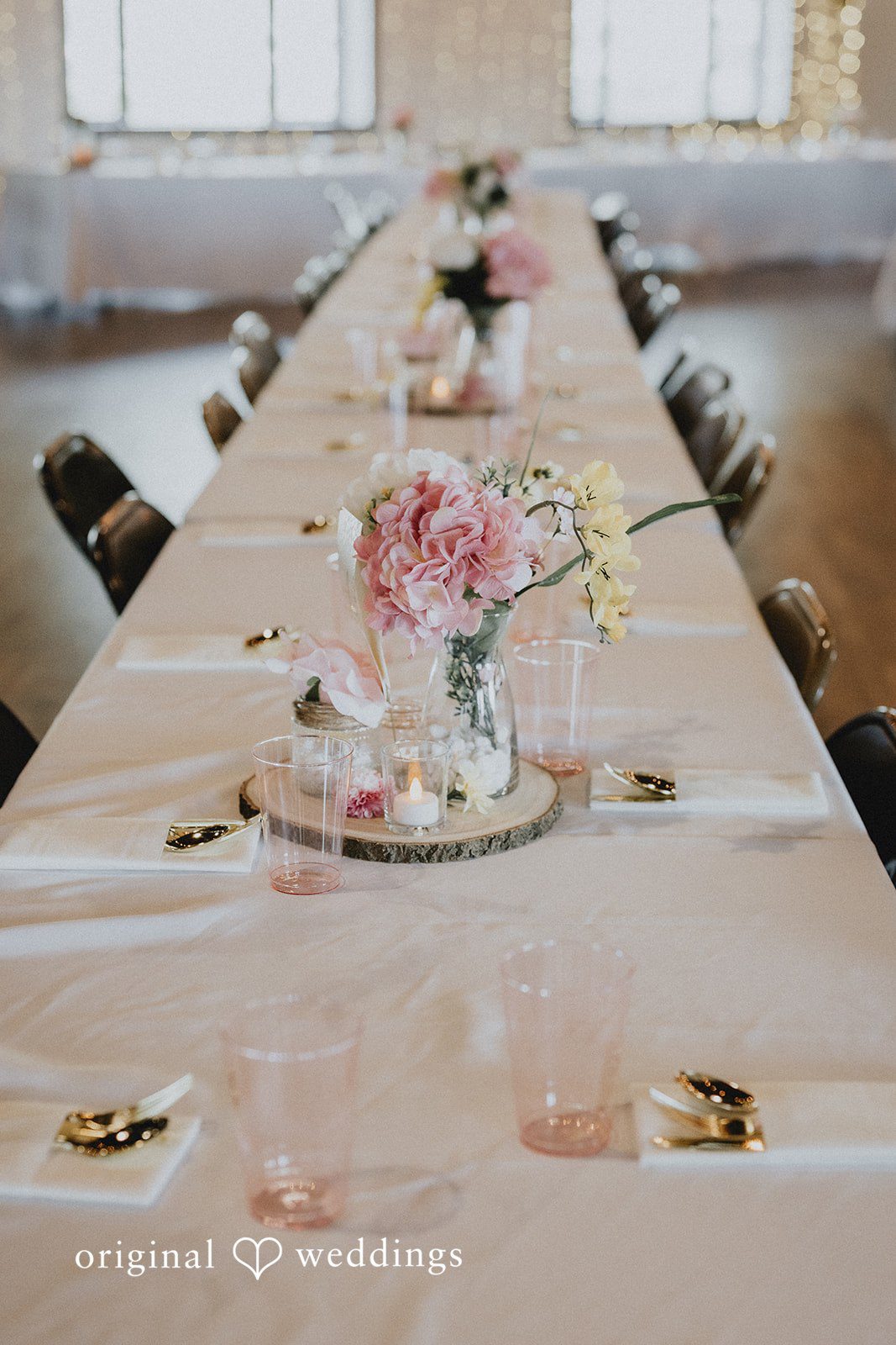 Emily + Ethan Long decorated dining table with a light pink runner and centerpieces.