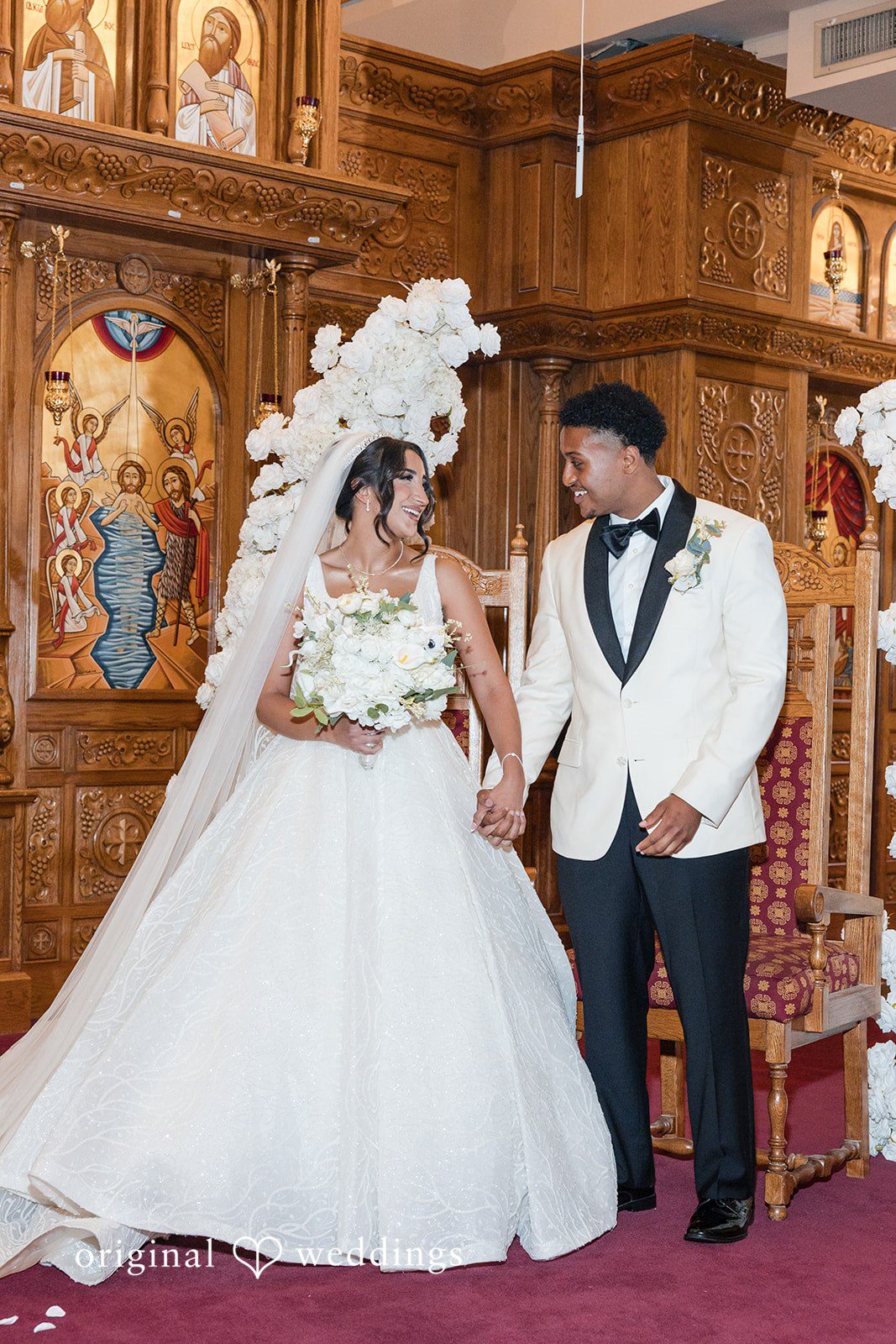 A bride and groom walking down the aisle together after getting married.