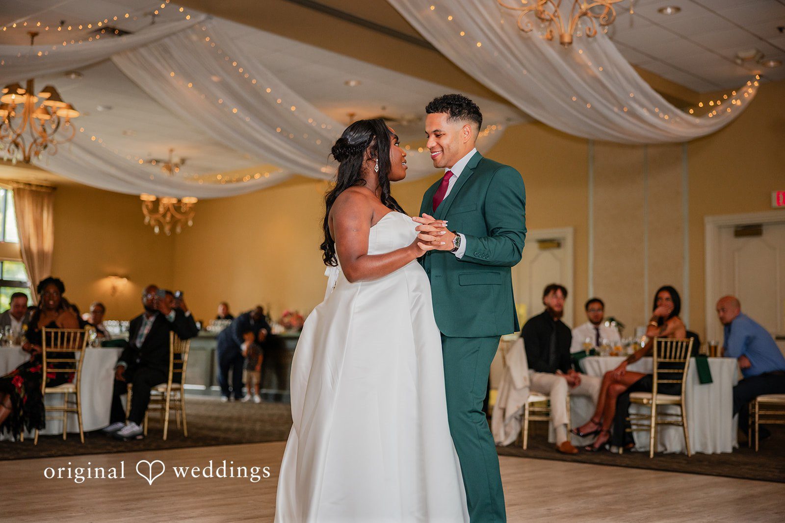 Christopher + Maxine Bride and groom slow dancing close together on the reception dance floor.