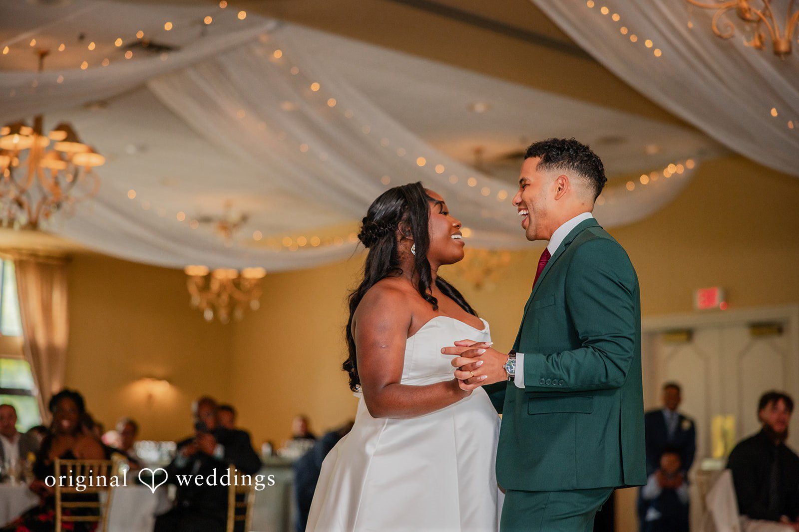 Christopher + Maxine Bride and groom sharing their first dance under draped ceiling fabrics.