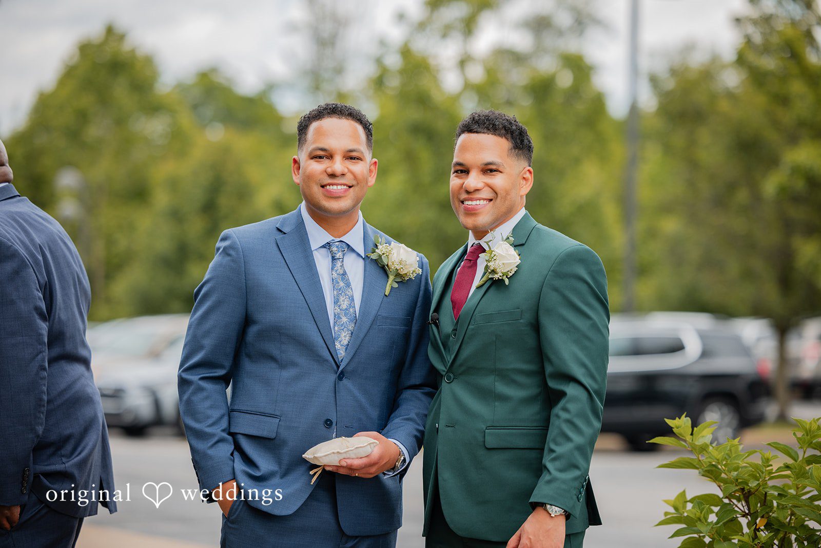 Christopher + Maxine Two men standing next to each other posing in formal suits.