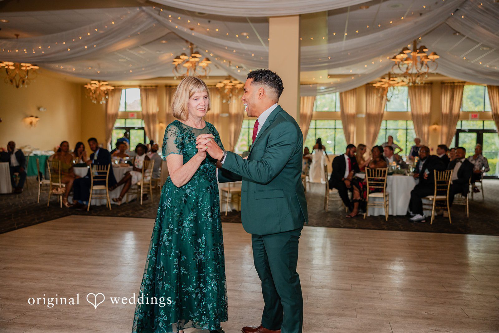 Christopher + Maxine Groom dancing with a woman wearing a green textured gown during the reception.