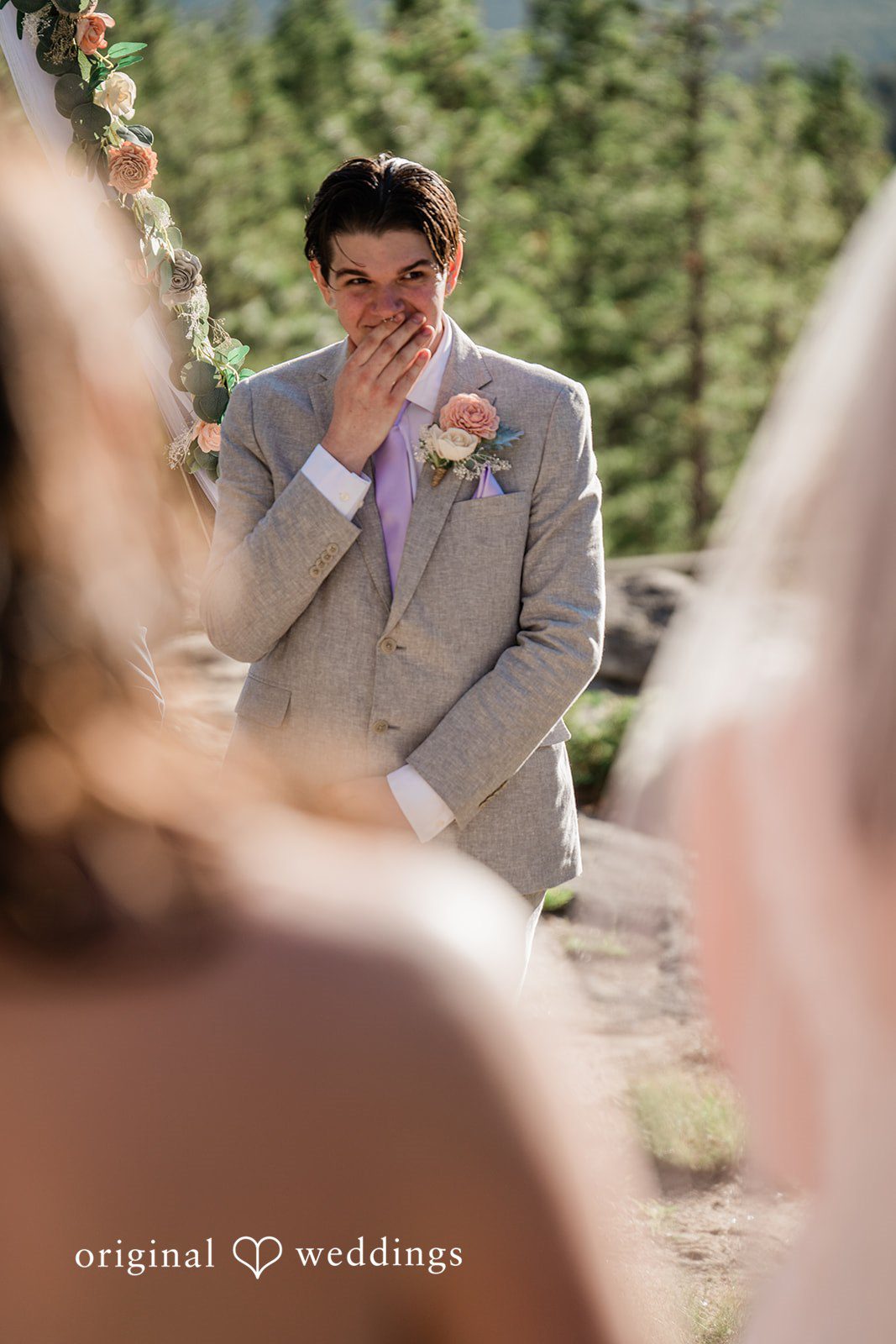 Madelyn + Erin A groom wiping tears from his face during a wedding ceremony.