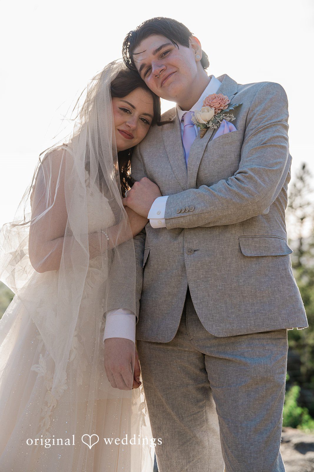 Madelyn + Erin A bride leaning gently against the groom's shoulder while he holds her hand.