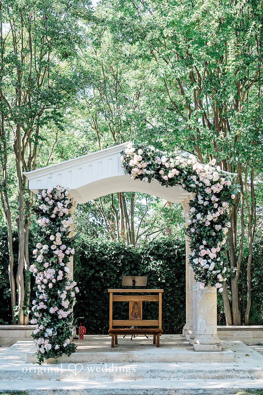 Lindsay + Ryan An elegant floral wedding arch standing at the end of an open ceremony space.