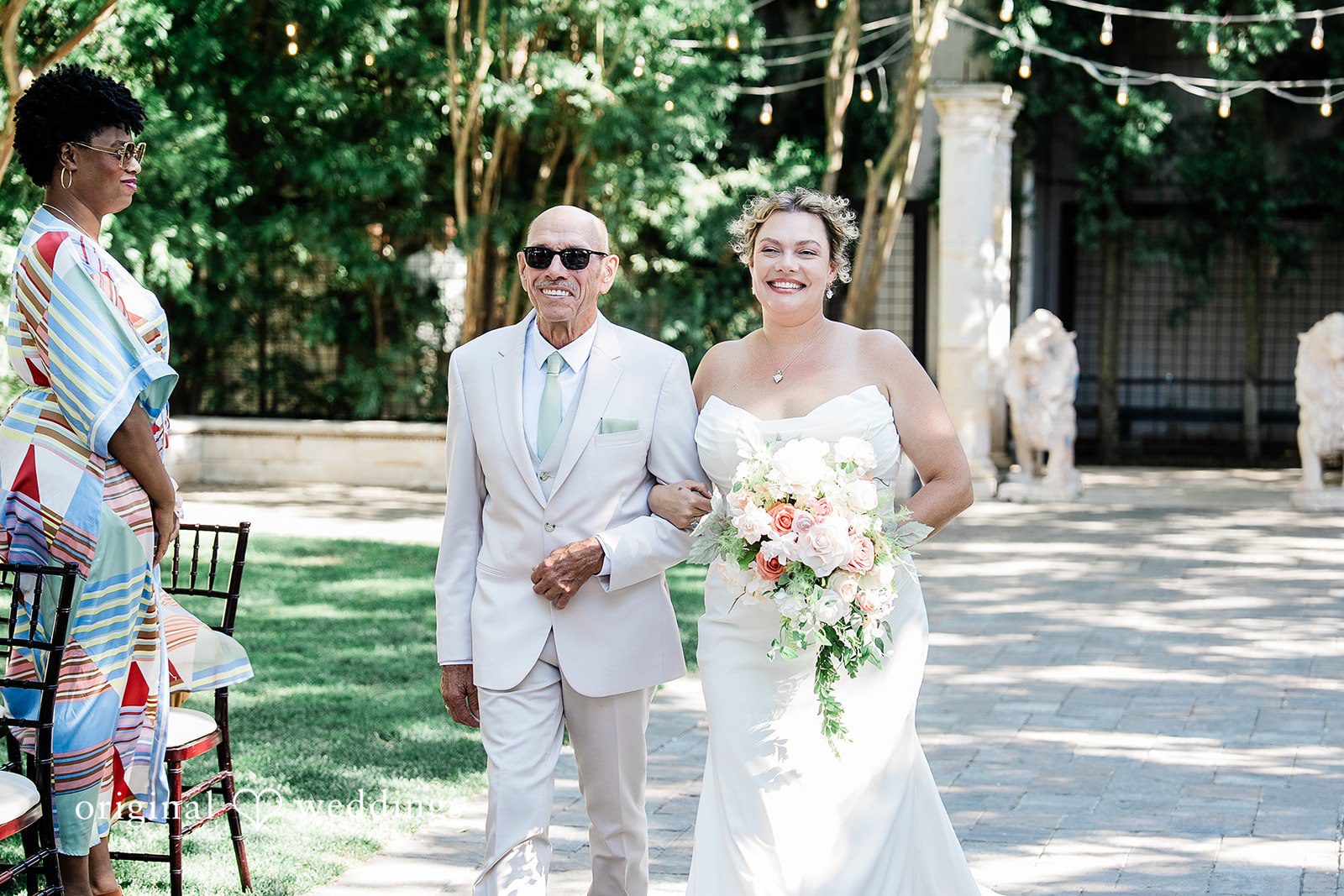 Lindsay + Ryan Bride walking down an aisle with a man.
