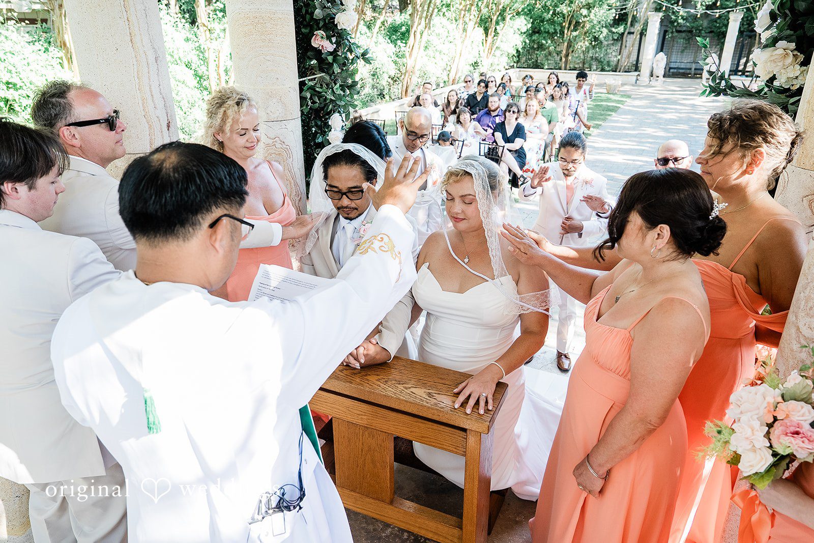 Lindsay + Ryan Guests gathered around a wedding altar during a bright daytime ceremony.