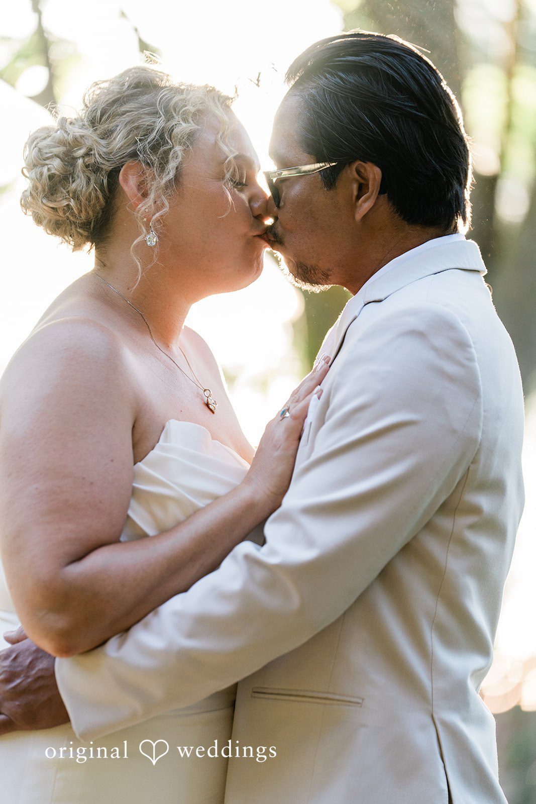 Lindsay + Ryan A close-up profile view of a bride and groom leaning in for a kiss.