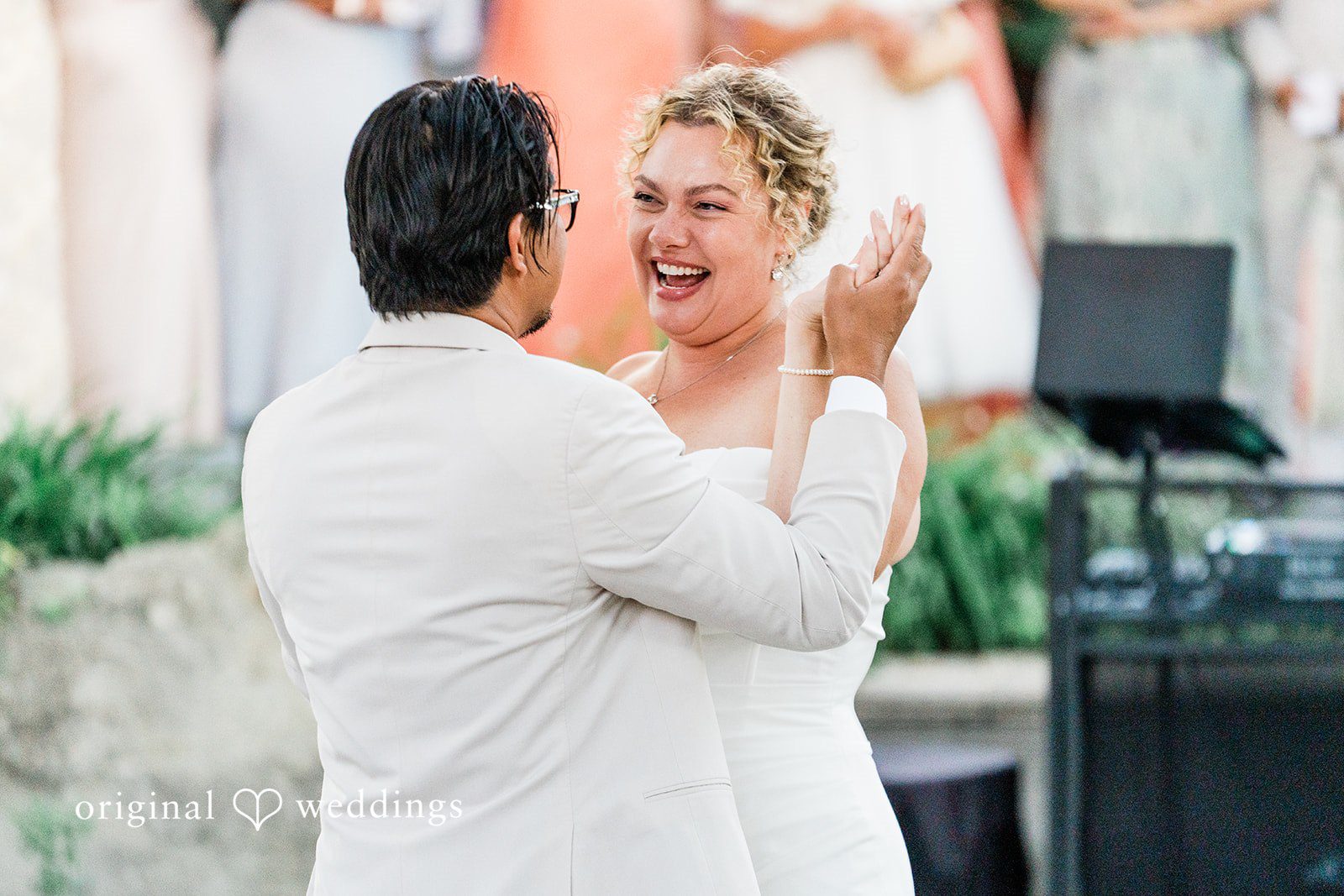 Lindsay + Ryan A groom with his back turned dancing happily with his smiling bride.