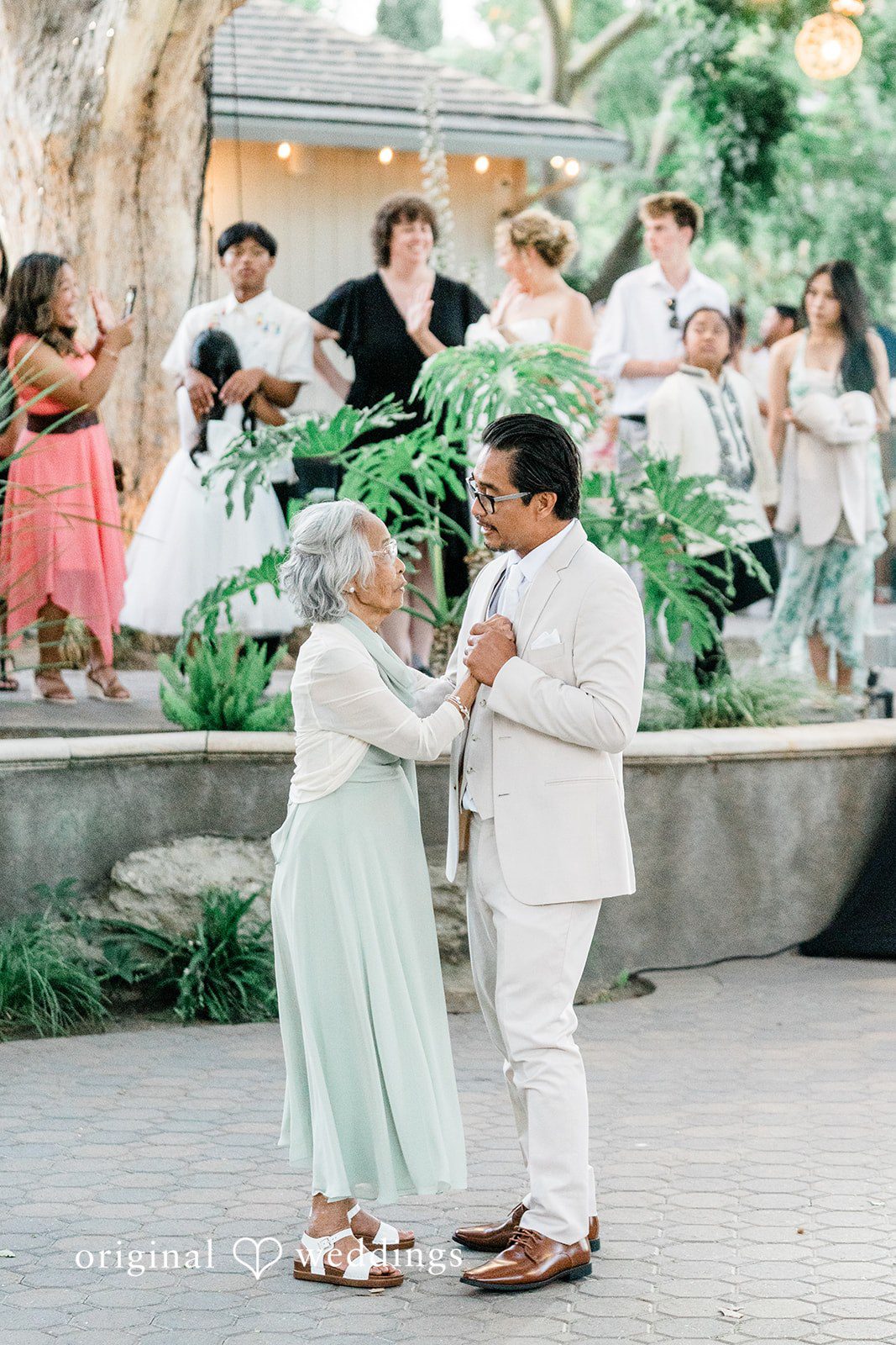 Lindsay + Ryan An older women and groom dancing together in the center of an open-air reception space.