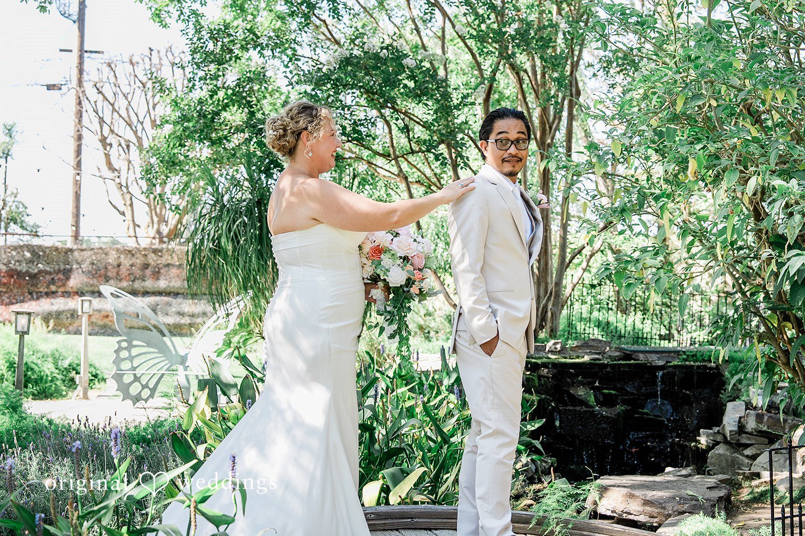 Lindsay + Ryan A bride and groom standing together face-to-face near a decorated altar space.