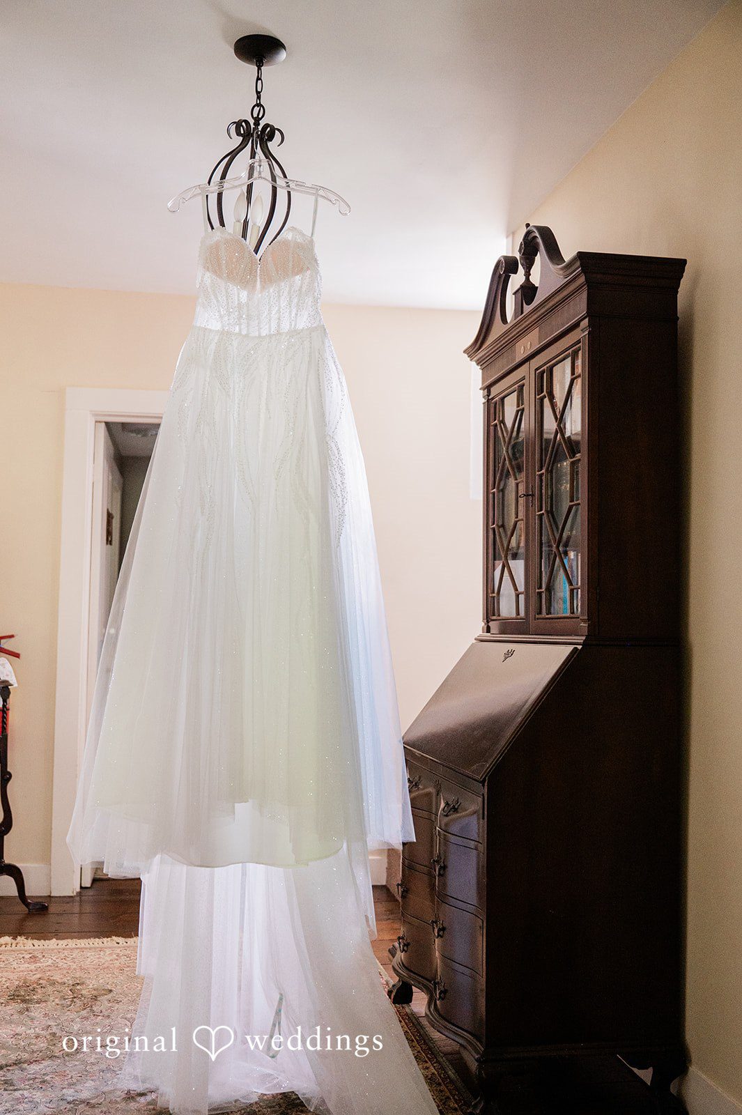 The bride's gown is gracefully hanging in the lodge