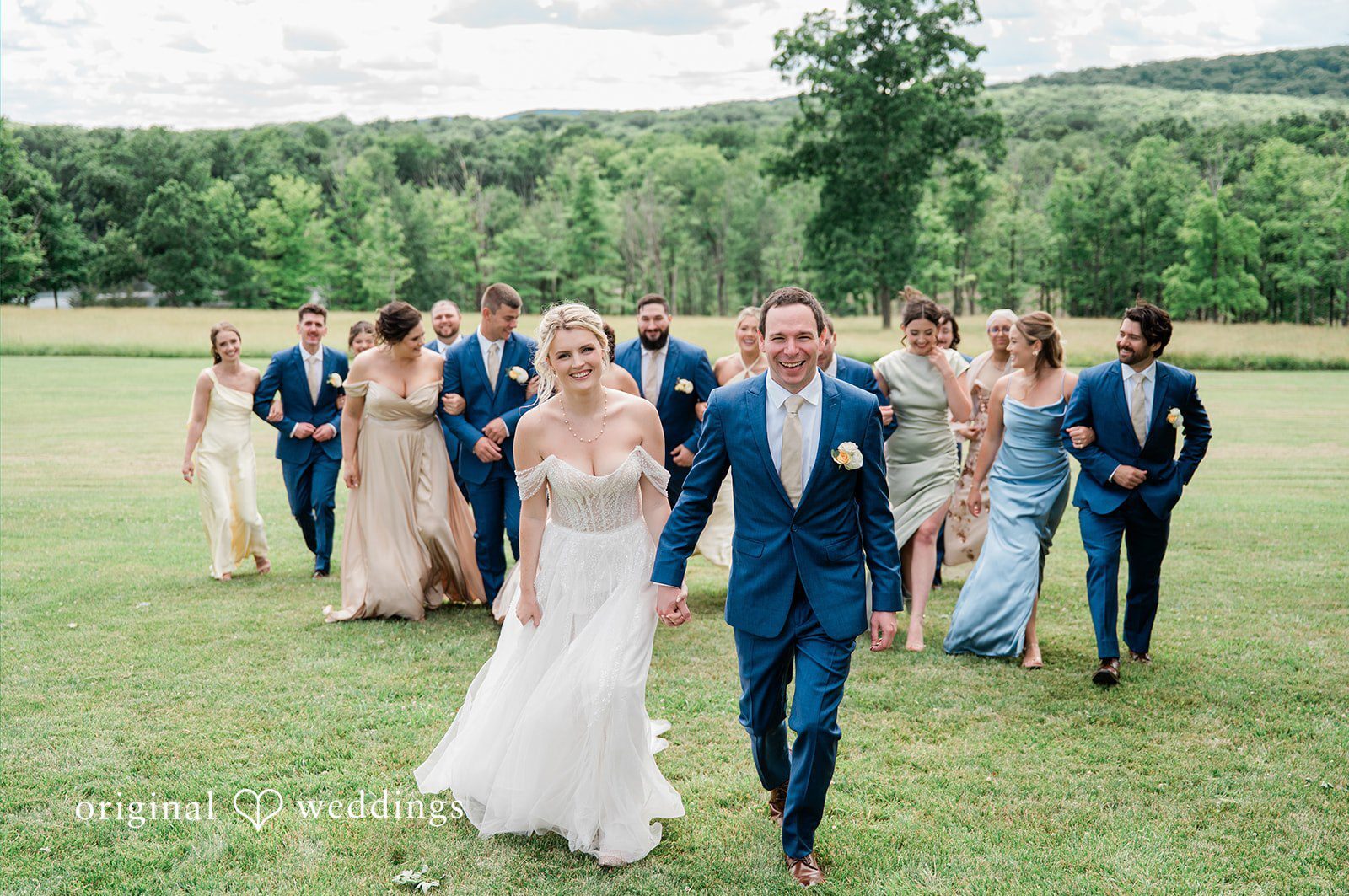 Our Hartford CT wedding photographers at Original Weddings captured a joyful portrait of the couple and their bridal party at Candlelight Farm