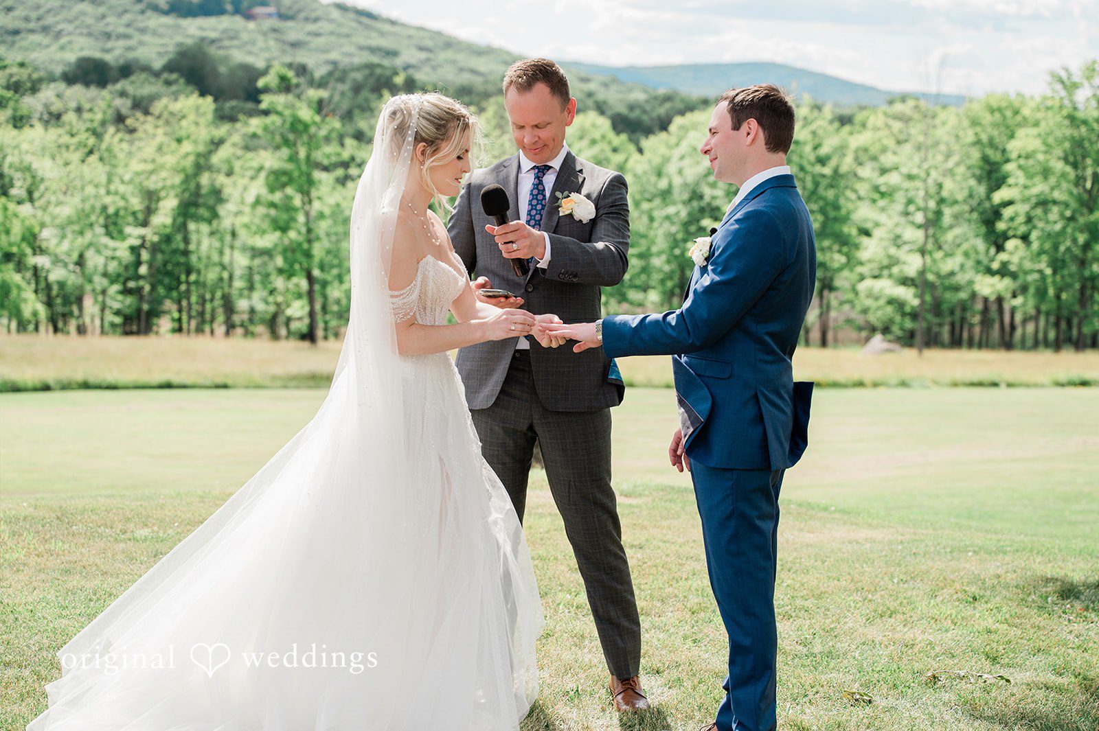 The bride puts a ring on the groom's finger