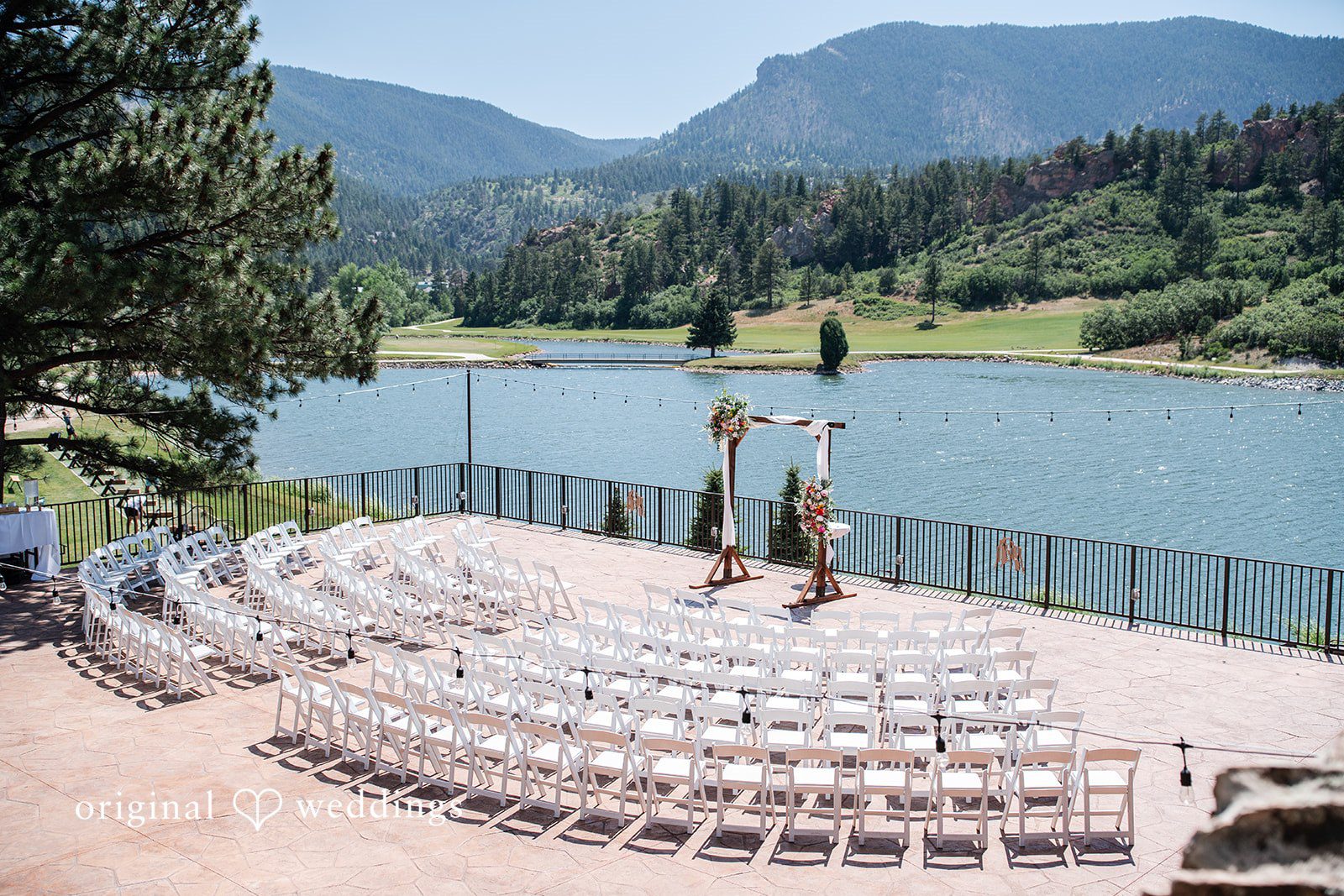 Mckenna + Ryan An empty amphitheater seating arrangement overlooking a lake.